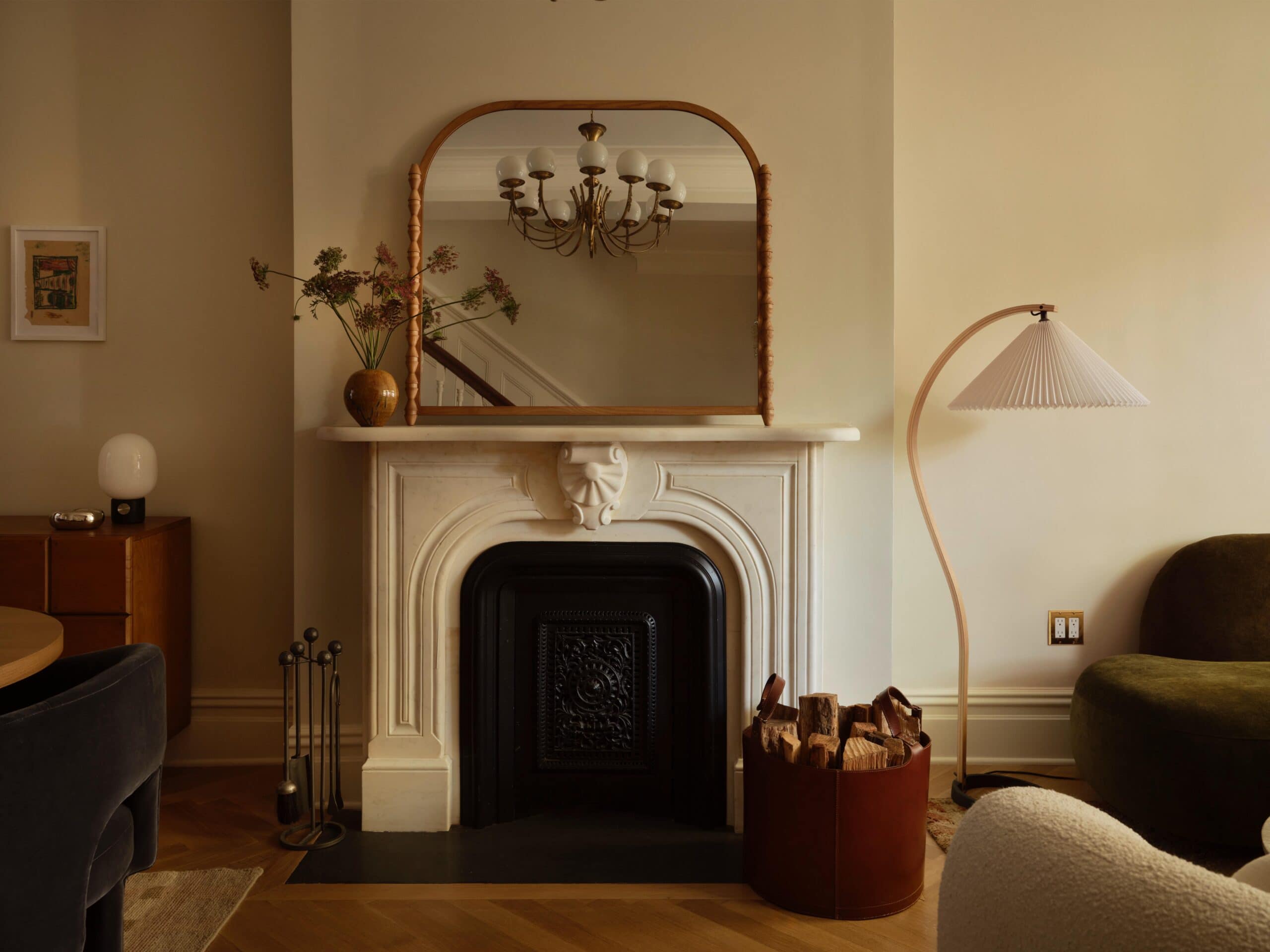 A fireplace with a mirror above it.